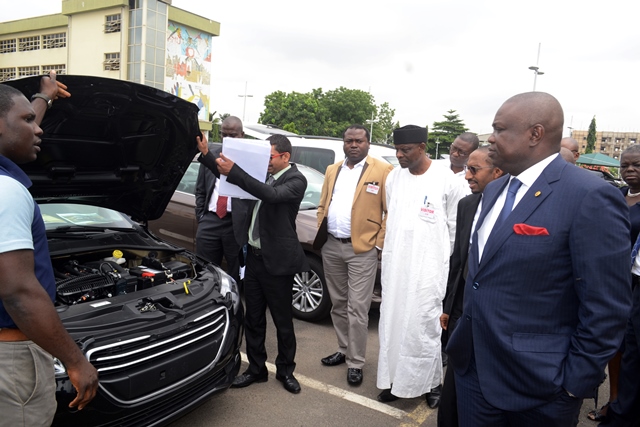 Lagos State Governor, Mr. Akinwunmi Ambode (right) being shown the engine compartment of a Peugeot car by the Showroom Manager, Auto Nation, Mr. Mishra Navendu (2nd left) during the visit by representatives of Peugeot Automobile Nigeria to the Governor at the Lagos House, Ikeja, on Wednesday, July 22, 2015. With them are Managing Director, Peugeot Automobile Nigeria, Mr. Boyi Ibrahim (2nd right), Executive Director, Finance, Peugeot Automobile Nigeria, Mr. Alli Jumad (3rd right) and the Chairman, Executive Group, Dr. Ayo Ogunsan (4th right).
