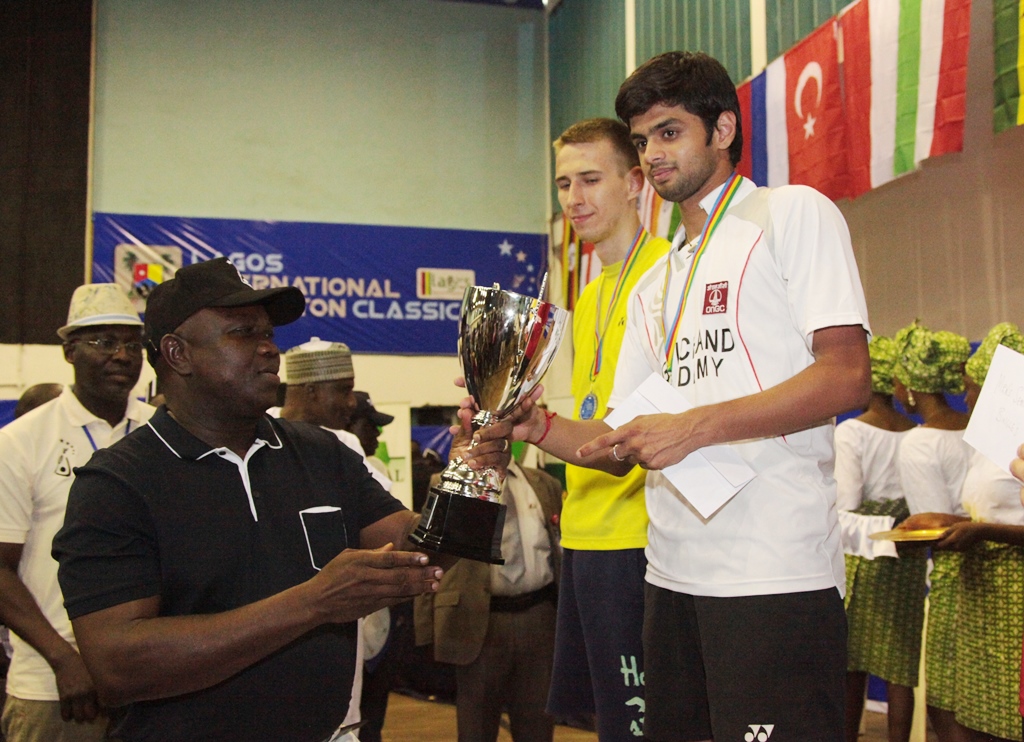 Lagos State Governor, Mr. Akinwunmi Ambode (left), presenting a trophy to the Winner of the Men’s single, Sai Praneeth from India (right) while the runner up, Dziolko Adrian from Poland (2nd right) watches with admiration during the Finals of the 2nd Lagos International Badminton Classics organized by Lagos State Badminton Association at Rowe Park, Yaba, Lagos, on Saturday, July 18, 2015.