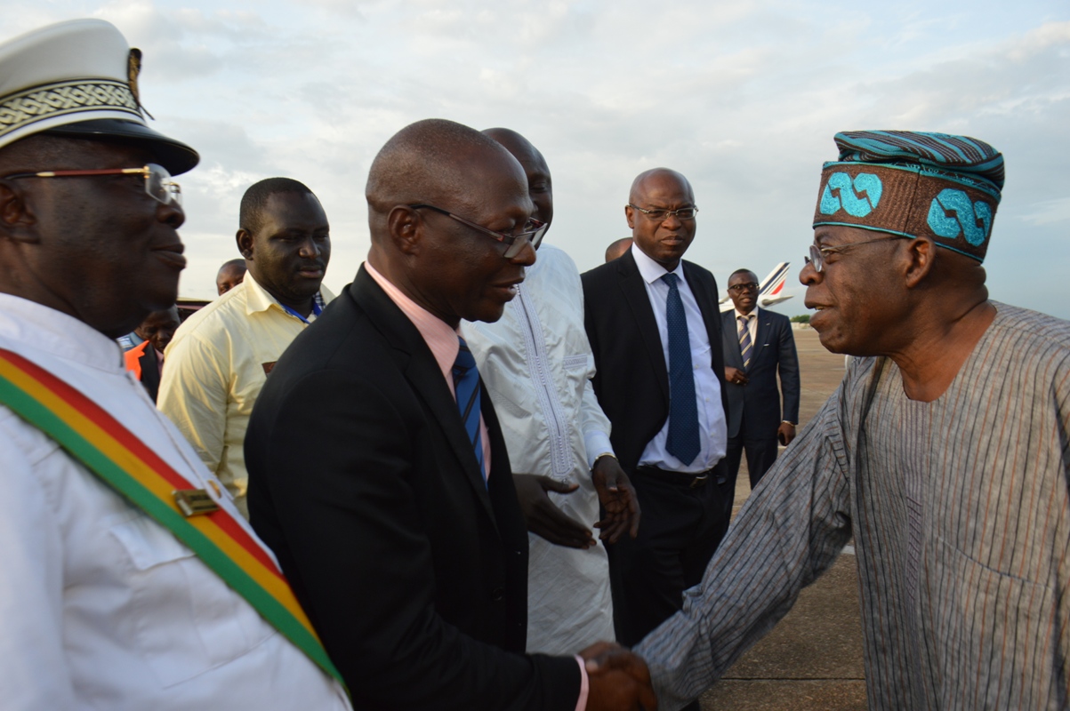 National Leader of APC, Asiwaju Bola Ahmed Tinubu, greeting Hon. Minister for Interior of Guinea, General Bourama Conde, and Governor of Conakry, Soriba Sorel Camara, at the Conakry International Airport, Guinea.