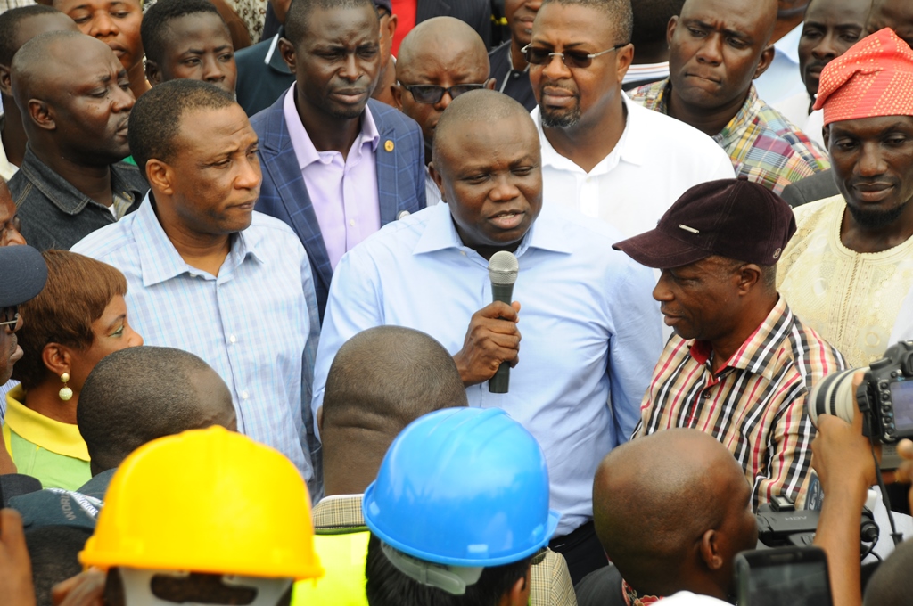 Lagos State Governor, Mr. Akinwunmi Ambode (middle) addressing residents during his inspection of Ipaja road, Estate Gate Bus stop, Ipaja, on Wednesday, August 19, 2015. With him are the Secretary to the State Government, Mr Tunji Bello (left), member, Lagos State House of Assembly, Alimosho Constituency, Hon. Bisi Yusuf (right) and others during the Governor’s inspection of  Ipaja road, Estate Gate Bus stop, Ipaja, on Wednesday, August 19, 2015.
