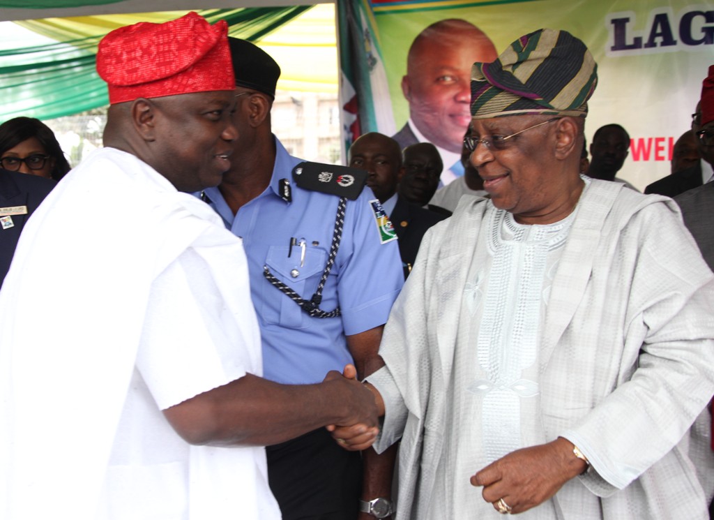 Lagos State Governor, Mr. Akinwunmi Ambode (left), exchanging  pleasantries with the State Chairman, All Progressives Congress (APC), Otunba Henry Ajomale (right) during the commissioning of 20 Mobile Care Unit and 26 Number Transport Ambulances at Lagos House, Ikeja, on Monday, August 31, 2015.