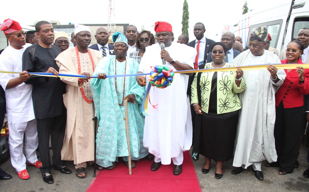 Lagos State Governor, Mr. Akinwunmi Ambode (4th right) cutting the tape to commission the 20 Mobile Care Unit and 26 Number Transport Ambulances at Lagos House, Ikeja, on Monday, August 31, 2015. With him are Deputy Governor, Dr. (Mrs.) Oluranti Adebule (3rd right), State Chairman, All Progressives Congress (APC), Otunba Henry Ajomale (2nd right), Head of Service, Mrs. Folasade Jaji (right),
the Alara of IIlara-Epe, Oba Hakeem Adesanya (4th left), the Opeluwa of Lagos, chief Lateef Ajose (3rd left), Senator Ganiyu Solomon (2nd right) and the Deputy Speaker, Lagos State House of Assembly, Hon. Wasiu Eshinlokun  Sanni (left).