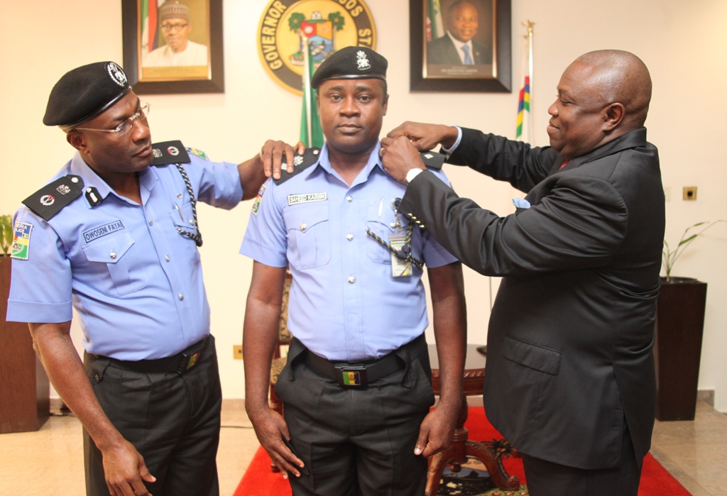 Lagos State Governor, Mr. Akinwunmi Ambode (right) and the Commissioner of Police, Mr. Fatai Owoseni (left) decorating the Chief Security Officer  (CSO) to the Governor, Mr. Saheed Kassim (middle) who was promoted from Superintendent of Police (SP) to Chief Superintendent of Police (CSP) at the Lagos House, Ikeja, on Tuesday, August 11, 2015.