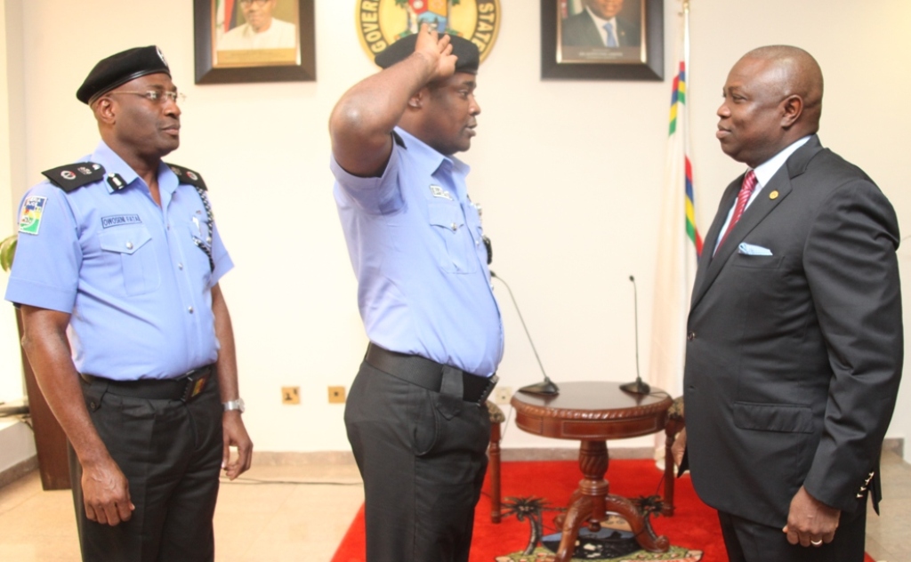 Lagos State Governor, Mr. Akinwunmi Ambode (right) being saluted by his Chief Security Officer (CSO), Mr. Saheed Kassim (middle) while the Commissioner of Police, Mr. Fatai Owoseni (left) watches during the decoration of the CSO to the Governor as Chief Superintendent of Police (CSP) at the Lagos House, Ikeja, on Tuesday, August 11, 2015.
