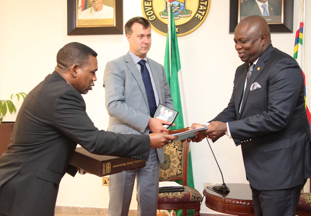 Lagos State Governor, Mr. Akinwunmi Ambode (right) receiving Transition briefing notes on DFID partnership with Lagos State Government from South West Regional Coordinator, DFID, Head of Lagos Office, Mr. Sina Fagbenro-Byron (left) while the Head, DFID Nigeria, Mr. Ben Mellor (left) looks on during a courtesy visit to the Governor by DFID, at the Lagos House, Ikeja, on Tuesday, August 18, 2015.