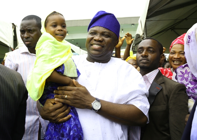 Lagos State Governor, Mr. Akinwunmi Ambode (middle) carrying a young muslimah during the Eid-el-Kabir Celebration organized by the Ministry of Home Affairs at the Lagos House, Ikeja, on Thursday, September 24, 2015.