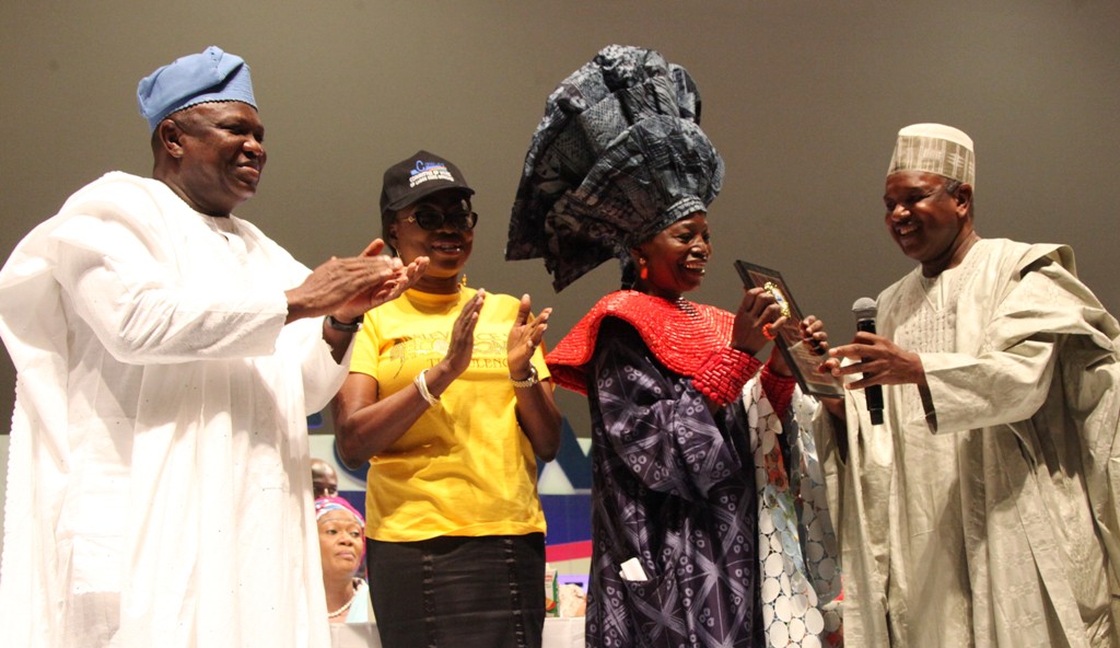 Lagos State Governor, Mr. Akinwunmi Ambode (left) his wife & Chairman, Committee of Wives of Lagos State Officials (COWLSO), Mrs. Bolanle Ambode (2nd left), Kebbi State Governor, Alhaji Atiku Bagudu (right) presenting an award of Inspiration Woman of the Year to the C.E.O, Nike Art Foundation, Chief (Mrs.) Nike Okundaye (2nd right) during the opening ceremony of the annual National Women Conference organized by COWLSO, at the Convention Centre, Eko Hotels & Suite on Wednesday, September 16, 2015.