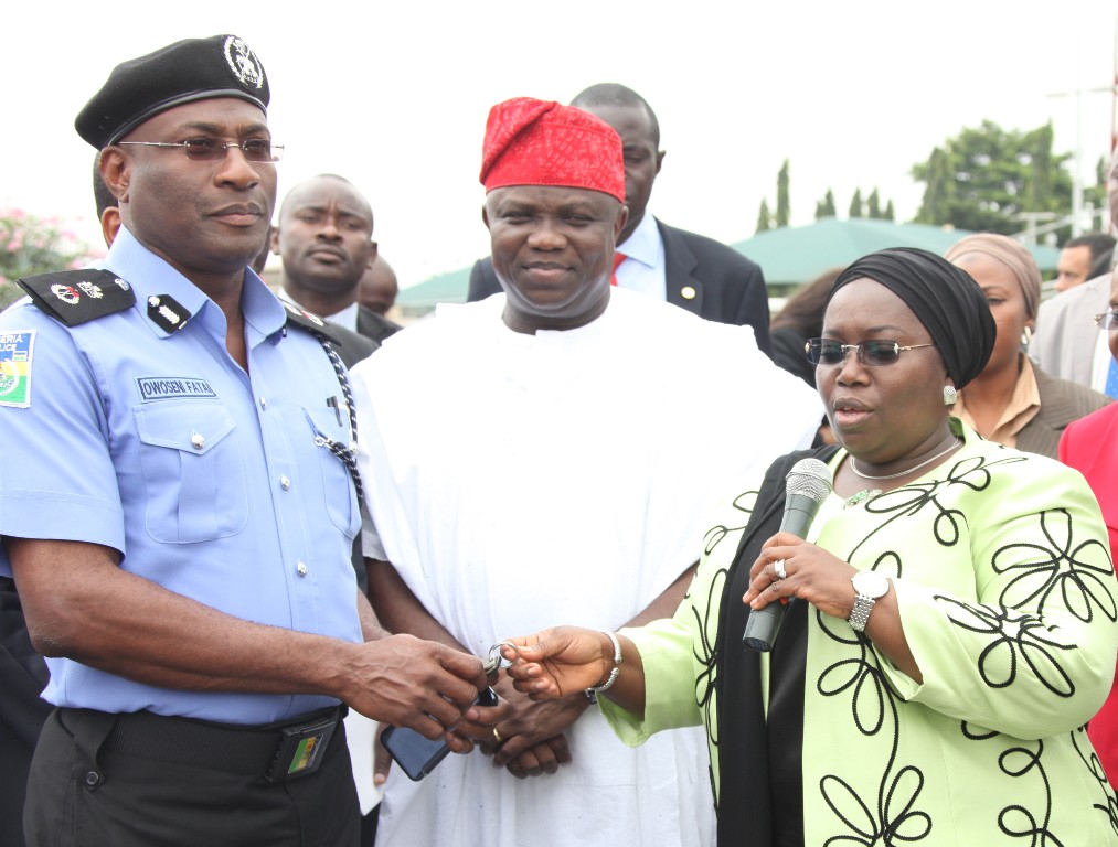 Lagos State Governor, Mr. Akinwunmi Ambode (middle) watches with admiration as his Deputy, Dr. (Mrs.) Oluranti Adebule (right) hands over keys of 10 Patrol Vehicles and 15 motorbikes to the State Commissioner of Police, Mr. Fatai Owoseni (left), at the at Lagos House, Ikeja, on Monday, August 31, 2015.