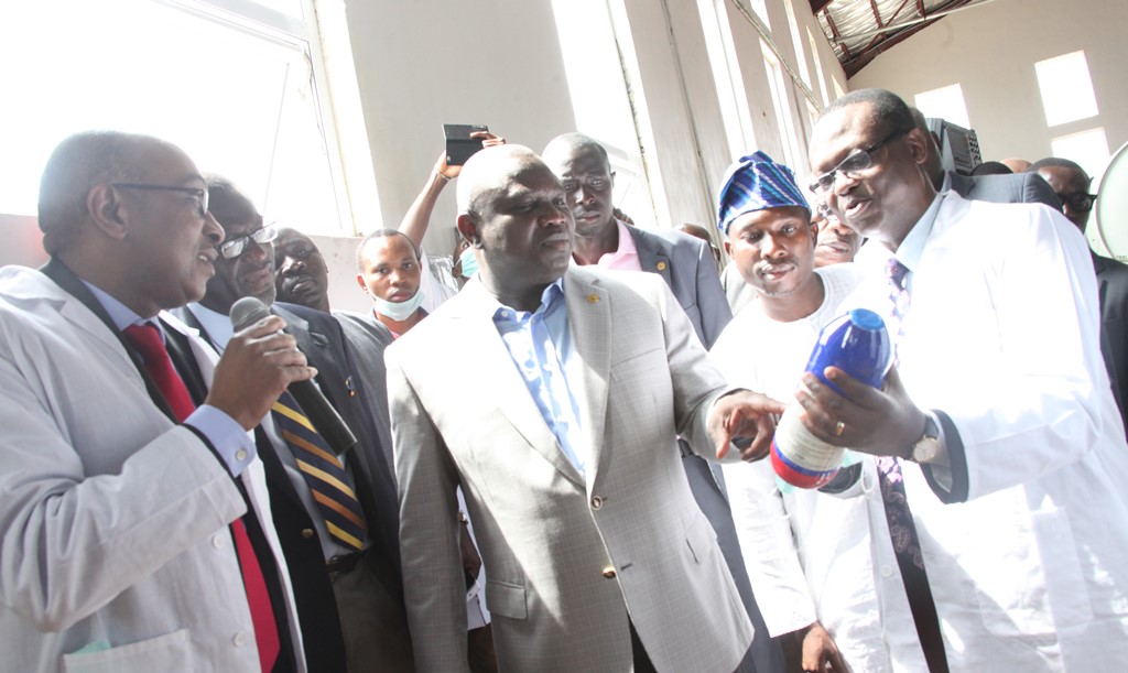 Lagos State Governor, Mr. Akinwunmi Ambode (middle) being shown a product  produced by Candel Company Limited from the Lekki Free Zone by the Chairman of the Company,  Mr. Charles Anudu (right),  while the Managing Director of the Company, Mr. Emmanuel Kattie (left), Deputy Managing Director, Lekki Free Zone Development Company, Mr. Adeyemo Thompson (2nd left) and Executive Secretary, Lekki Local Council Development Area, Mr. Kasali Bamidele Razak (2nd right) during the Governor’s inspection visit to the Candel Company Limited at the Lekki Free Zone, Imobido, Ibeju-Lekki, Lagos, on Wednesday, September 9, 2015.