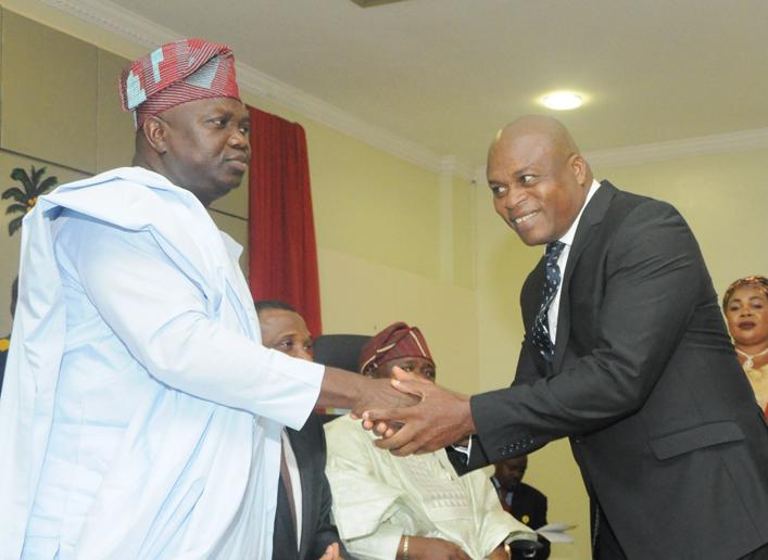 Lagos State Governor, Mr. Akinwunmi Ambode (left), congratulating Mr. Julius Adekunle (right), after being sworn in as Sole Administrator of Odi-Olowo Ojuwoye LCDA during the swearing-in of Sole Administrators of the 20 Local Governments and 37 Local Council Development Areas in the State, at the Banquet Hall, Lagos House, Ikeja on Monday, June 13, 2016.