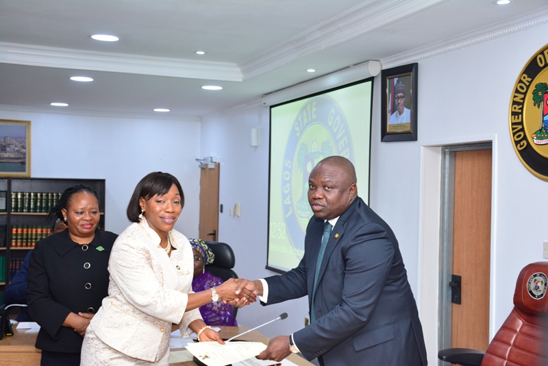 Lagos State Governor, Mr. Akinwunmi Ambode (right), congratulating Mrs. Toyin Idowu Awoseyi as Permanent Secretary, Civil Service Commission (right) while the Director, Legislative Drafting, Ministry of Justice, Mrs. Tola Akinsanya, watches during their Swearing-in at the EXCO Chamber, Lagos House, Ikeja, on Wednesday, October 12, 2016.