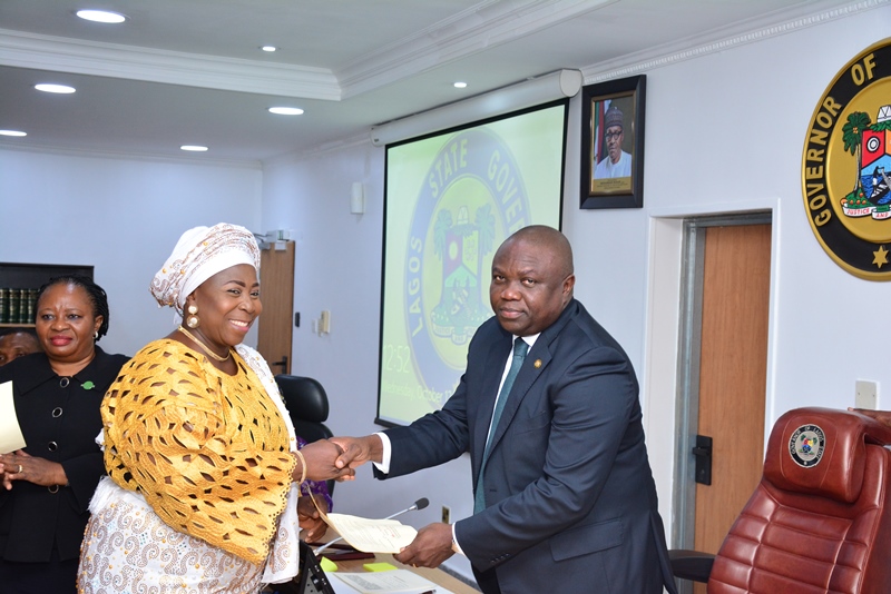 Lagos State Governor, Mr. Akinwunmi Ambode (right), congratulating Mrs. Amudat Elizabeth Adekanye (left) after being sworn-in as PS/Tutor General, Education District V, at the EXCO Chamber, Lagos House, Ikeja, on Wednesday, October 12, 2016.