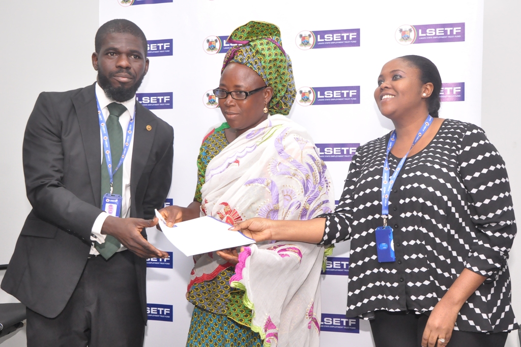  Executive Secretary, Lagos State Employment Trust Fund (LSETF), Mr. Akin Oyebode (left); Director, Strategy Funding & Stakeholder Engagement, LSETF, Mrs. Abosede Alimi (right), jointly presenting a Offer Letter to a successful applicant, Mrs. Sukurat Modupe Alausa during the distribution of Offer Letters to beneficiaries of the N25 Billion Employment Trust Fund (ETF) Pilot Scheme at the LSETF Office, Oregun, Ikeja, on Friday, December 30, 2016.