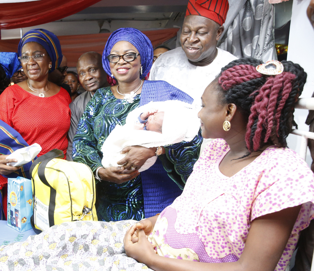 Wife of Lagos State Governor, Mrs. Bolanle Ambode (middle), carrying the Baby of the Year, mother of the baby of the year, Mrs. Aderonke Akande (right); Special Adviser to the Governor on Primary Healthcare, Dr. Olufemi Onanuga (2nd right); Commissioner for Health, Dr. Jide Idris (2nd left); COWLSO member, Prof. Ibiyemi Bello during the presentation of gifts to Baby of the Year, born 12:01am, weighing 3.1kg at the Lagos Island Maternity Hospital, Lagos, on Sunday, January 01, 2017.​