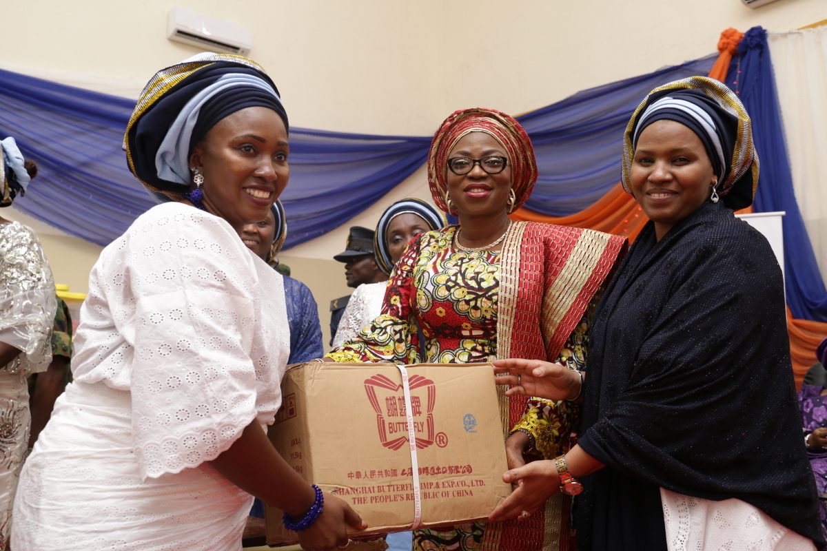 Wife of Lagos State Governor, Mrs. Bolanle Ambode (2nd right), being supported by the National President of Nigerian Air Force Officers Wives Association (NAFOWA), Hajiya Hafsat Abubakar (right), to present empowerment tools to one of the grandaunts, Mrs. Hajara Yusuf (left) during the graduation and closing ceremony of NAFOWA Skills Acquisition and Vocational Training program for the youths and women, at the Sam Ethnan Air Force Base, Ikeja, on Thursday, 27 April, 2017.