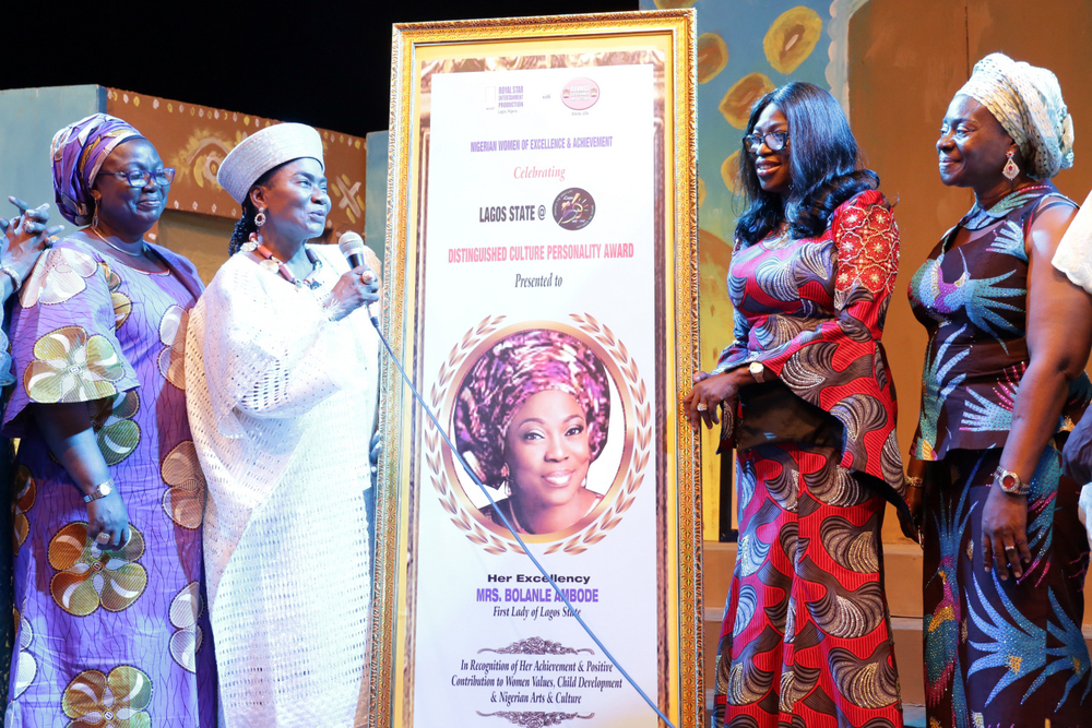 Wife of Lagos State Governor, Mrs. Bolanle Ambode (2nd right); being presented with an award of Distinguished Culture Personality by Erelu Abiola Dosunmu (2nd left) as the Special Adviser to the Governor on Tourism, Arts & Culture, Mrs. Adebimpe Akinsola (left) and Princess Bolanle Kazeem (right), watch during the presentation of a stage play titled “The Travails of Erelu Kuti, the Queen Mother”, in honour of Mrs. Ambode, at the Muson Centre, Onikan, Lagos, on Sunday, May 21, 2017.