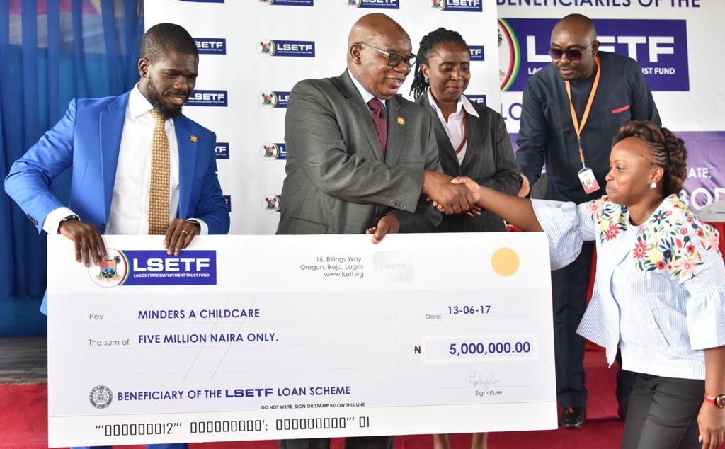 Representative of Lagos State Governor & Commissioner for Wealth Creation & Employment, Dr. Babatunde Durosinmi-Etti (2nd left), congratulates a beneficiary, Minder A Childcare (right) while Chairman, LSETF, Mrs. Ifueko Omoigui Okauru (2nd right) and Executive Secretary, Lagos State Employment Trust Fund (LSETF), Mr. Akin Oyebode (left), watch during the LSETF Cheque presentation ceremony at the De Blue Roof, LTV, Agidingbi, Ikeja, on Tuesday, June 13, 2017.