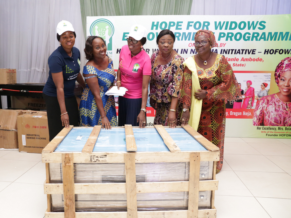 Founder, Hope for Women in Nigeria Initiative (HOFOWEM) and Wife of Lagos State Governor, Mrs. Bolanle Ambode (middle); supported by Commissioner for Women Affairs & Poverty Alleviation, Hon. Lola Akande (2nd right); Acting Commissioner for Tourism, Arts & Culture, Hon. Adebimpe Akinsola (right) and CEO, HOFOWEM, Ms. Oyefunke Adeleke (left) to present brand new Industrial Oven to one of the beneficiaries, Mrs. Celestina Osundiya during the Hope For Widows Empowerment Programme for 103 beneficiaries to celebrate the 2017 International Widow’s Day, at the Excel Events Centre, Oregun, Ikeja, Lagos, on Thursday, June 29, 2017.