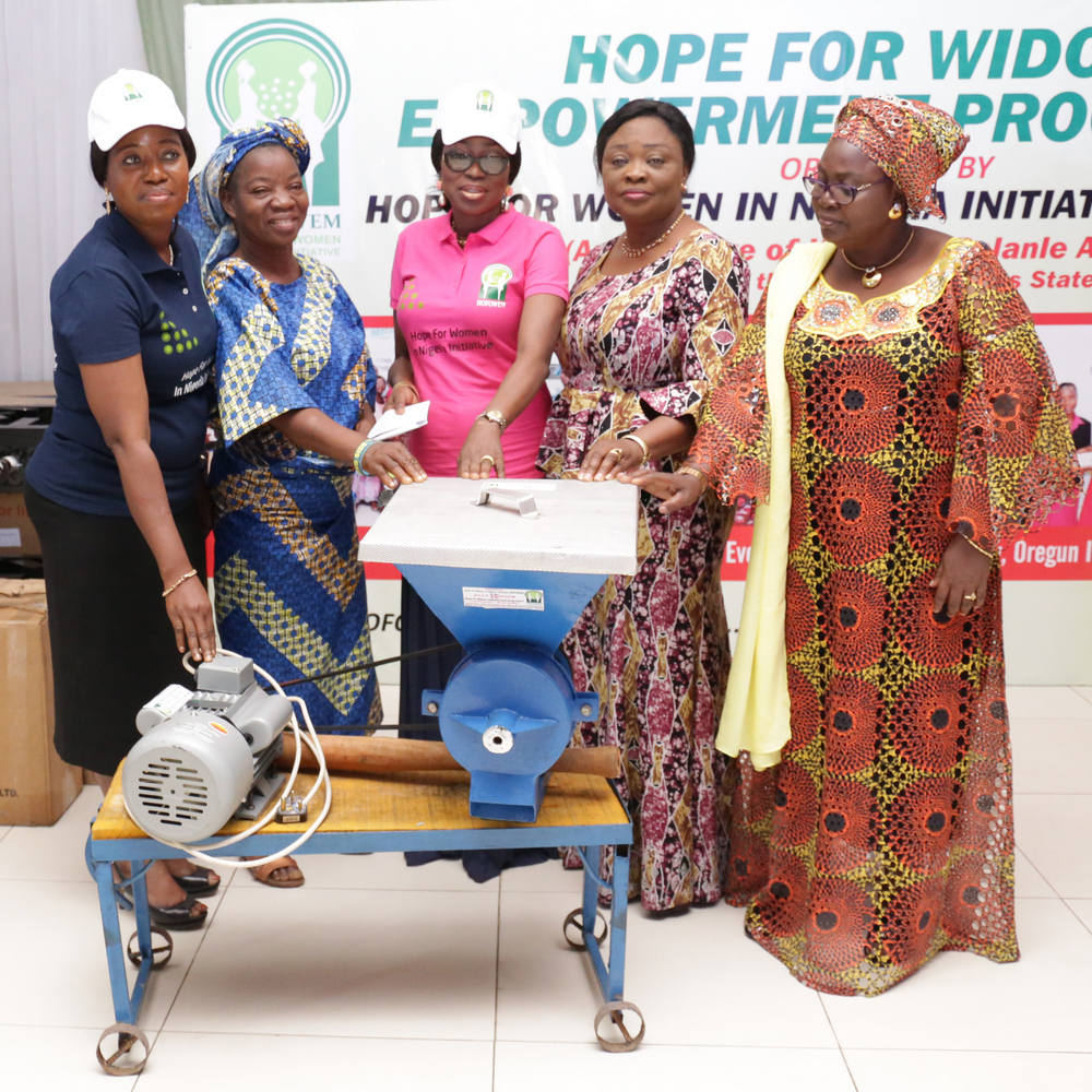 Founder, Hope for Women in Nigeria Initiative (HOFOWEM) and Wife of Lagos State Governor, Mrs. Bolanle Ambode (middle); supported by CEO, HOFOWEM, Ms. Oyefunke Adeleke (left); Commissioner for Women Affairs & Poverty Alleviation, Hon. Lola Akande (2nd right) and Acting Commissioner for Tourism, Arts & Culture, Hon. Adebimpe Akinsola (right) to present a brand new grinding machine to one of the beneficiaries, Mrs. Oke Adeyanju (2nd left) during the Hope For Widows Empowerment Programme for 103 beneficiaries to celebrate the 2017 International Widow’s Day, at the Excel Events Centre, Oregun, Ikeja, Lagos, on Thursday, June 29, 2017.