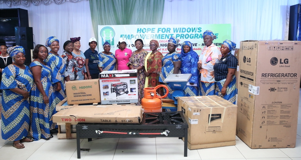Founder, Hope for Women in Nigeria Initiative (HOFOWEM) and Wife of Lagos State Governor, Mrs. Bolanle, (7th right); CEO, HOFOWEM, Ms. Oyefunke Adeleke (6th left); APC Southwest Women Leader, Chief (Mrs.) Kemi Nelson (5th left); Head of Service, Mrs. Olabowale Ademola (4th left); Commissioner for Women Affairs & Poverty Alleviation, Hon. Lola Akande (6th right); Acting Commissioner for Tourism, Arts & Culture, Hon. Adebimpe Akinsola (5th right) with some beneficiaries and their empowerment tools during the Hope For Widows Empowerment Programme for 103 beneficiaries to celebrate the 2017 International Widow’s Day, at the Excel Events Centre, Oregun, Ikeja, Lagos, on Thursday, June 29, 2017.