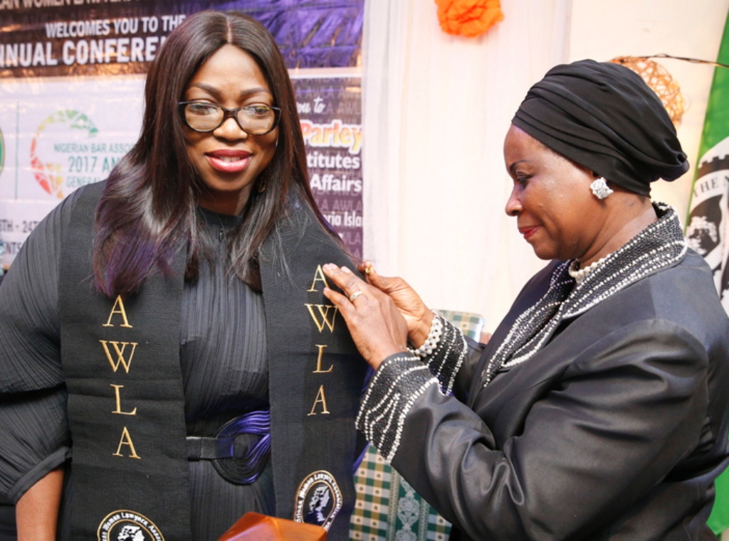 Wife of Lagos State Governor, Mrs. Bolanle Ambode (left), being decorated as “Matron and mother of the African child”, by the African Women Lawyers’ Association - Nigeria, during the AWLA parley, as part of activities marking the Annual General Conference of Nigerian Bar Association (NBA), at Victoria Island, Lagos, recently