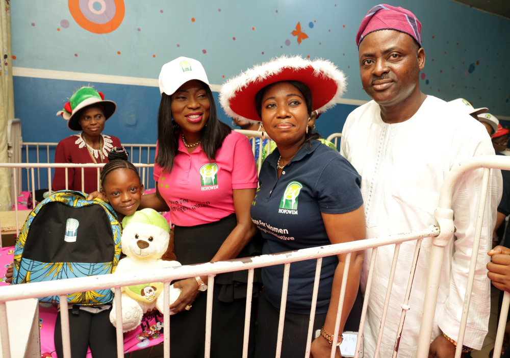 Wife of the Governor of Lagos State & founder, Hope for Women in Nigeria Initiative (HOFOWEM), Mrs Bolanle Ambode (m) supported by CEO. HOFOWEM, Ms. Oyefunke Adeleke (2nd right); and MD. Massey Street Children’s Hospital, Lagos, Dr. Olugbenga Aina  (r), to present Xmas gifts to Miss Zainab Kotun (2nd left), during the distribution of various gift items to more than 500 children at Massey Hospital and Sought After Orphanage Home, Langbassa, Ajah, by HOFOWEM, tagged: ‘Love at Christmas’, at Massey Street Children’s Hospital, Lagos, on Monday, 25th December, 2017. 
