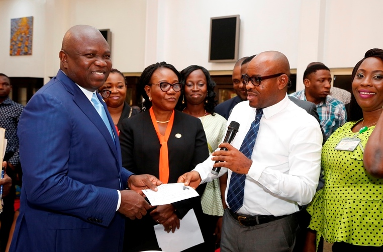  Lagos State Governor Mr. Akinwunmi Ambode (left), being presented with his Temporary National Identification Number slip (NIN) by the Lagos Regional Coordinator, National Identity Management Commission (NIMC), Mr. Kayode Adegoke (2nd right) at the Banquet Hall, Lagos House, Ikeja, on Wednesday, February 14, 2018. With them are Head of Service, Lagos State, Mrs. Folasade Adesoye (2nd left) and State Coordinator, Lagos West, NIMC, Funmilola Opesanwo (right