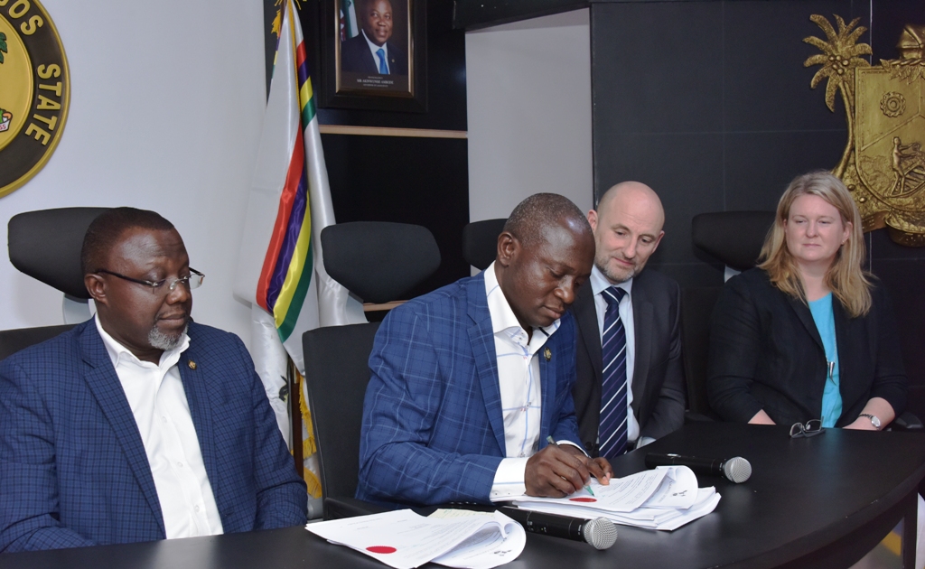 Lagos State Commissioner for Energy & Mineral Resources Mr. Olawale Oluwo (2nd left), signing the Memorandum of Understanding (MoU) on 10,000 Street Lighting project with Low Energy Designs Company Limited at the Lagos House, Alausa, Ikeja, on Monday, March 5, 2018. With him are Special Adviser to the Governor on Lagos Global, Prof. Ademola Abass (left); CEO, Low Energy Designs Company Limited, Mr. Alan Parker (2nd right) and Head of Trade, West Africa, Department of International Trade UK, Kate Rudd (right).  