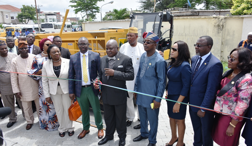 Representative of Lagos State Governor and Commissioner for Physical Planning & Urban Development, Mr. Rotimi Ogunleye (5th right); Commissioner for Establishment, Training & Pensions, Dr, Akintola Benson (4th right);  Senior Management, Asset Management Corporation of Nigeria (AMCON), Miss Prisca Ndu (3rd right); Special Adviser to the Governor, Office of Overseas Affairs & Investment, Prof. Ademola Abass (2nd right); Head of Service, Mrs. Folasade Adesoye (right); Managing Director, Infrastructure Development & Energy Company (INDECO), Mr. Eric Opah (5th left) and other members of the State Executive Council during the commissioning of the newly Procured Construction Equipment for the State’s Public Works and Drainages, at Edward Hotonu Road, Lekki Phase 1, Lagos, on Wednesday, May 16, 2018.