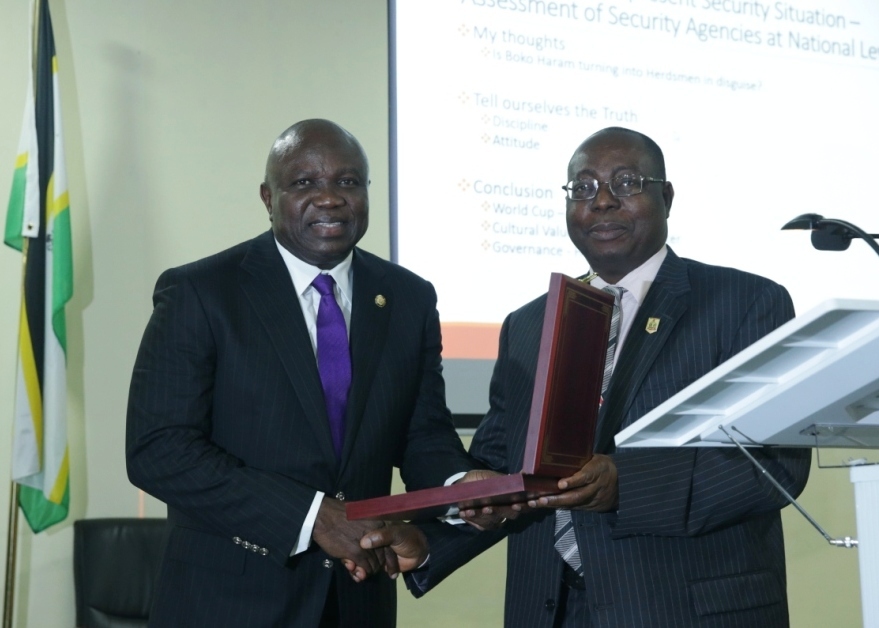 Lagos State Governor, Mr. Akinwunmi Ambode (left), being presented with a plaque by the Director of Institute for Security Studies, Mr. Matthew Seiyfa during the 2018 Executive Management Course of the Institute for Security Studies in Abuja, on Tuesday, July 24, 2018.