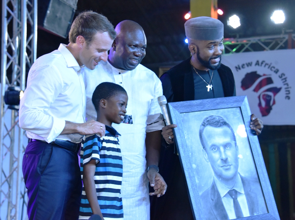 Lagos State Governor, Mr. Akinwunmi Ambode (middle), with President of France, Mr. Emmanuel Macron (left); Nigerian Music Act, Bankole Wellington ‘Banky W’ (right) when Master Karim Olamilekan presented a painting of the French President during the celebration of African Culture at the Afrika Shrine, Ikeja, Lagos, on Tuesday, July 3, 2018